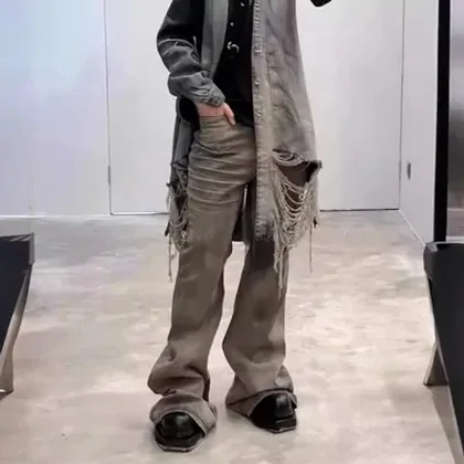 Loose brown-grey denim trousers worn with a jacket