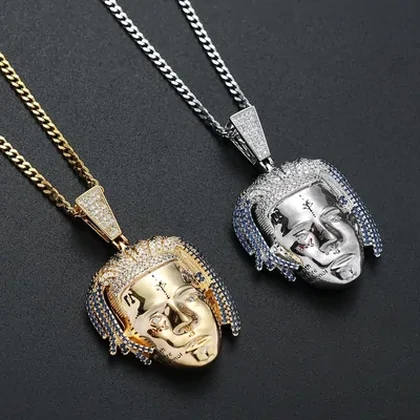 Gold and silver pendant necklaces on dark fabric