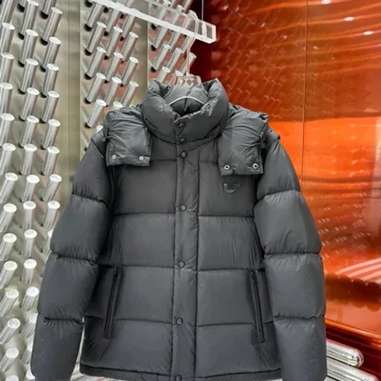 Grey puffer jacket hanging in front of an orange wall